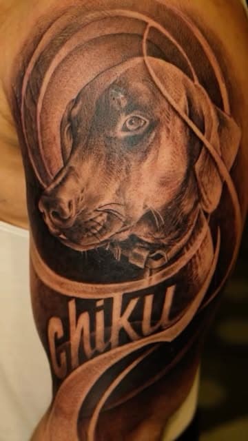 Dog portrait tattoo with the name Chiku
