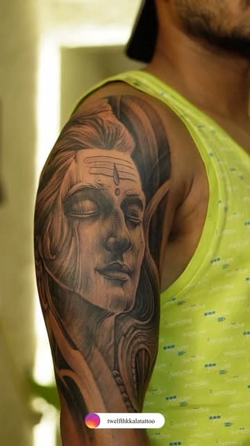 Lord Shiva portrait tattoo on a shoulder