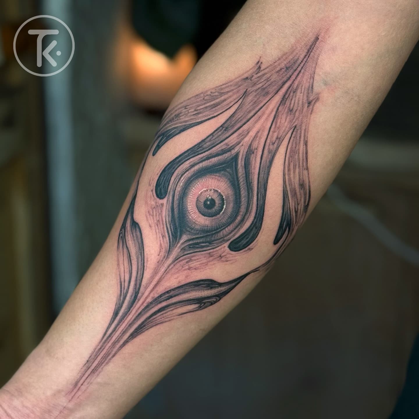 Trishul and third eye tattoo on a forearm